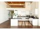 Modern kitchen design features white cabinets, black countertops, and bar stool seating at 500 N Duke St # 53104, Durham, NC 27701