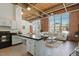 Open-concept space with brick walls, large windows, and modern decor at 500 N Duke St # 53104, Durham, NC 27701