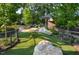 Dog park with rolling green hills and artificial turf, offering a safe and fun environment for pets at 600 Hedrick Ridge Road # 306, Cary, NC 27519