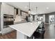 Modern kitchen with stainless steel appliances, gray cabinets, white countertops and island with bar stool seating at 600 Hedrick Ridge Road # 306, Cary, NC 27519