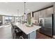Modern kitchen with stainless steel appliances, gray cabinets, white countertops and island with bar stool seating at 600 Hedrick Ridge Road # 306, Cary, NC 27519