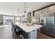 Modern kitchen with stainless steel appliances, gray cabinets, white countertops and island with bar stool seating at 600 Hedrick Ridge Road # 306, Cary, NC 27519