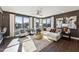 Bright living room with large windows, hardwood floors, comfortable seating, and stylish décor at 600 Hedrick Ridge Road # 306, Cary, NC 27519