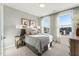 Comfortable bedroom with an abundance of natural light, neutral colors and decorative pictures hung on the walls at 600 Hedrick Ridge Road # 312, Cary, NC 27519