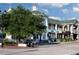 Charming commercial exterior with a blend of green roof tops, lush landscaping and multiple storefronts at 600 Hedrick Ridge Road # 312, Cary, NC 27519