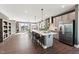Modern kitchen features a large island with seating, stainless steel appliances, and a view to the living area at 600 Hedrick Ridge Road # 312, Cary, NC 27519