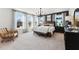 This main bedroom features large windows, a neutral color palette, and a chandelier for added elegance at 600 Hedrick Ridge Road # 312, Cary, NC 27519