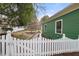 Charming backyard with green siding, white fence, and walkway at 603 Polk St, Raleigh, NC 27604