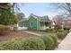 Charming green home with a cozy front porch and well-maintained landscaping at 603 Polk St, Raleigh, NC 27604