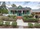 Charming green bungalow featuring a welcoming front porch and manicured landscaping at 603 Polk St, Raleigh, NC 27604