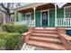 Inviting front porch with brick steps, a charming green door, and stylish details at 603 Polk St, Raleigh, NC 27604