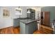 Modern kitchen with custom cabinetry, a stylish island, and stainless steel appliances at 603 Polk St, Raleigh, NC 27604