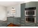 Well-appointed kitchen with stainless steel ovens, updated cabinets, and a sink at 603 Polk St, Raleigh, NC 27604