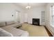 Spacious living room with a comfortable couch, a decorative fireplace, and ample natural light at 603 Polk St, Raleigh, NC 27604