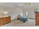 Bedroom with vaulted ceiling features neutral carpet, windows, and traditional-style wood furniture at 6100 River Laurel Ct, Raleigh, NC 27604