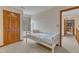 Spare bedroom with a twin bed, wood door, and natural light from the window at 6100 River Laurel Ct, Raleigh, NC 27604