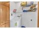 Utility room featuring a white washing machine with storage shelves at 6100 River Laurel Ct, Raleigh, NC 27604