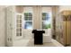 Bright home office featuring modern desk, chair, shelving, stylish lighting and an open door, perfect for productivity at 620 Vega Bluff Ln, Angier, NC 27501