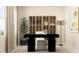 Home office featuring a modern black desk, white chair, and stylish display cabinet, complemented by contemporary decor at 620 Vega Bluff Ln, Angier, NC 27501