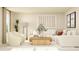 Sunlit living room with white sectional sofa, comfortable chairs, and a decorative wood coffee table at 620 Vega Bluff Ln, Angier, NC 27501