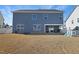 Rear exterior view showing a spacious backyard with a covered patio and ample natural light at 624 Red Arrow Dr, Knightdale, NC 27545