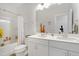 Bright bathroom featuring double sinks, a large mirror, and tub with shower at 624 Red Arrow Dr, Knightdale, NC 27545
