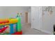 Bedroom featuring a colorful bounce house, cartoon-themed wall decals and neutral paint at 624 Red Arrow Dr, Knightdale, NC 27545