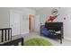 Bedroom with two cribs, a plush rug, a rocket-themed wall and a doorway to another room at 624 Red Arrow Dr, Knightdale, NC 27545