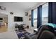 Comfortable bedroom featuring neutral carpet, large window, and modern gaming setup at 624 Red Arrow Dr, Knightdale, NC 27545