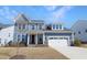 Charming two-story home boasts board and batten siding, stone accents, and an attached two-car garage at 624 Red Arrow Dr, Knightdale, NC 27545