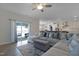 Bright living room featuring a large sectional sofa and a sliding glass door providing access to a patio at 624 Red Arrow Dr, Knightdale, NC 27545