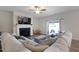 An open-concept living room with a fireplace, a large sectional sofa, and sliding glass doors at 624 Red Arrow Dr, Knightdale, NC 27545