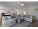 Spacious living room with a large sectional sofa, ceiling fan, and an open layout to the kitchen at 624 Red Arrow Dr, Knightdale, NC 27545