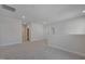 Spacious loft area with neutral paint, carpeted floors, and two entry ways at 624 Red Arrow Dr, Knightdale, NC 27545