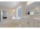 Bright primary bathroom with double vanity, large soaking tub, and view to bedroom at 624 Red Arrow Dr, Knightdale, NC 27545