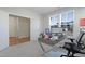Bright home office with a modern desk, two monitors, a large window, and light colored walls at 624 Red Arrow Dr, Knightdale, NC 27545