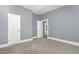 Bedroom with neutral walls, carpet flooring, and a door and doorway at 636 Tucker St, Burlington, NC 27215