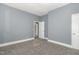 Bedroom with neutral walls, carpet flooring, and a doorway to another room at 636 Tucker St, Burlington, NC 27215
