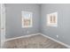 Bedroom with two windows, neutral walls, and carpet flooring at 636 Tucker St, Burlington, NC 27215