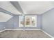 A carpeted bedroom with unique ceiling architecture and three bright windows at 636 Tucker St, Burlington, NC 27215