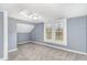 A blue carpeted bedroom with a double window and an interesting ceiling at 636 Tucker St, Burlington, NC 27215