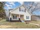 Charming two-story home featuring a welcoming front porch and a freshly painted red front door at 636 Tucker St, Burlington, NC 27215