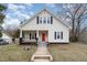 Charming two-story home featuring a welcoming front porch and a freshly painted red front door at 636 Tucker St, Burlington, NC 27215