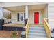 Inviting front porch with freshly painted features and a vibrant red door, adding curb appeal at 636 Tucker St, Burlington, NC 27215