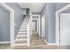 Hallway featuring stairs, neutral walls, and hardwood floors at 636 Tucker St, Burlington, NC 27215