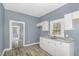 Bright kitchen with white cabinets, gray countertops, and hardwood floors at 636 Tucker St, Burlington, NC 27215