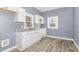 Bright kitchen with white cabinets, gray countertops, and hardwood floors at 636 Tucker St, Burlington, NC 27215