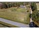 Expansive country estate featuring a classic brick home with a wraparound porch and a large front yard at 6404 Pulley Town Rd, Wake Forest, NC 27587