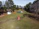 A peaceful scene of outbuildings surrounded by greenery, and bordered by tall and shady trees at 6404 Pulley Town Rd, Wake Forest, NC 27587