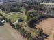 Wide aerial shot captures a brick home, verdant land, and nearby woods, offering peaceful, private living at 6404 Pulley Town Rd, Wake Forest, NC 27587